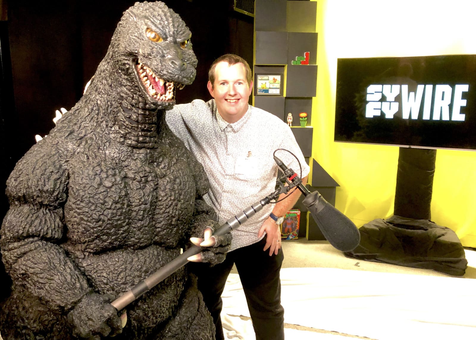 Special Effects Coordinator Matt and Godzilla pose for a photo at SYFY Wire NY